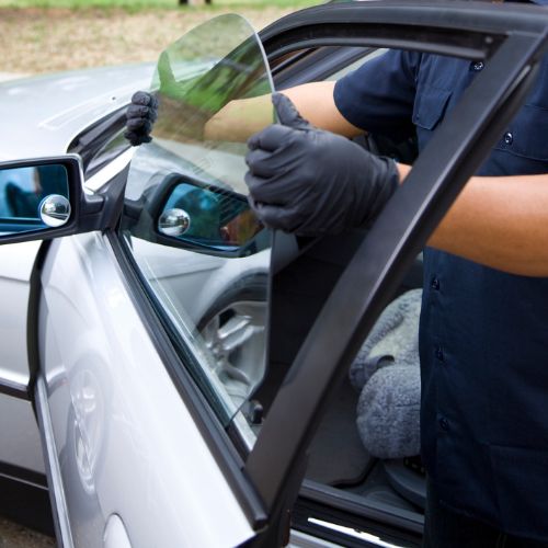 Closeup of new side window replacement in Chicago, IL sedan door.